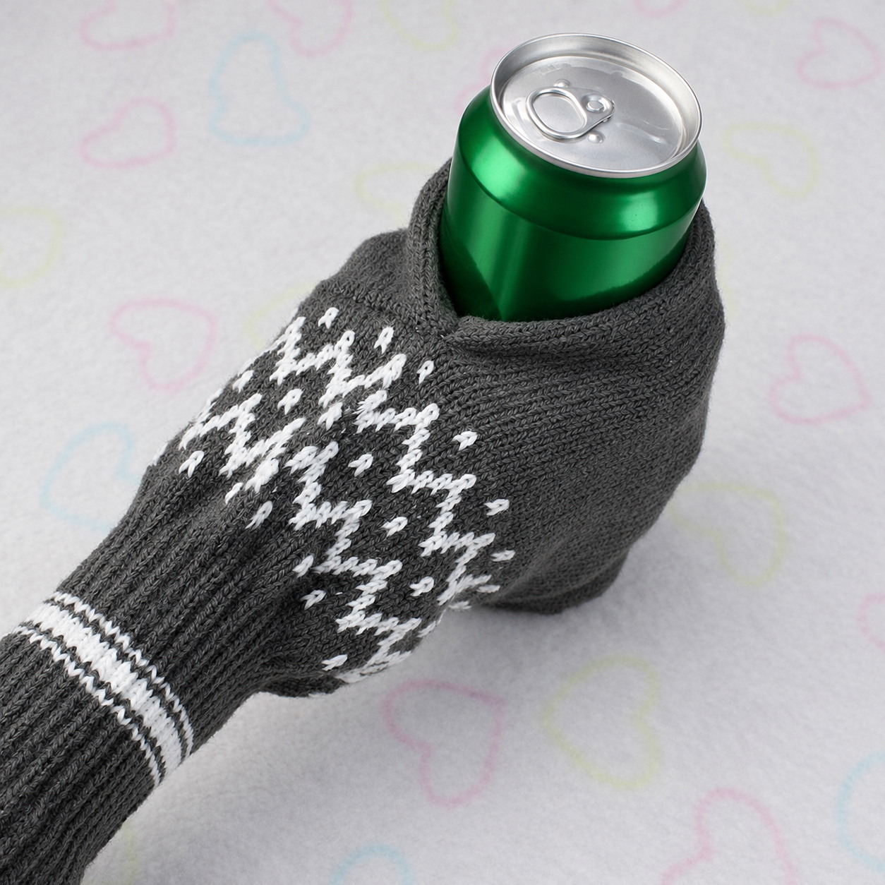 Gray knitted beer mitten holding an unbranded green beverage can