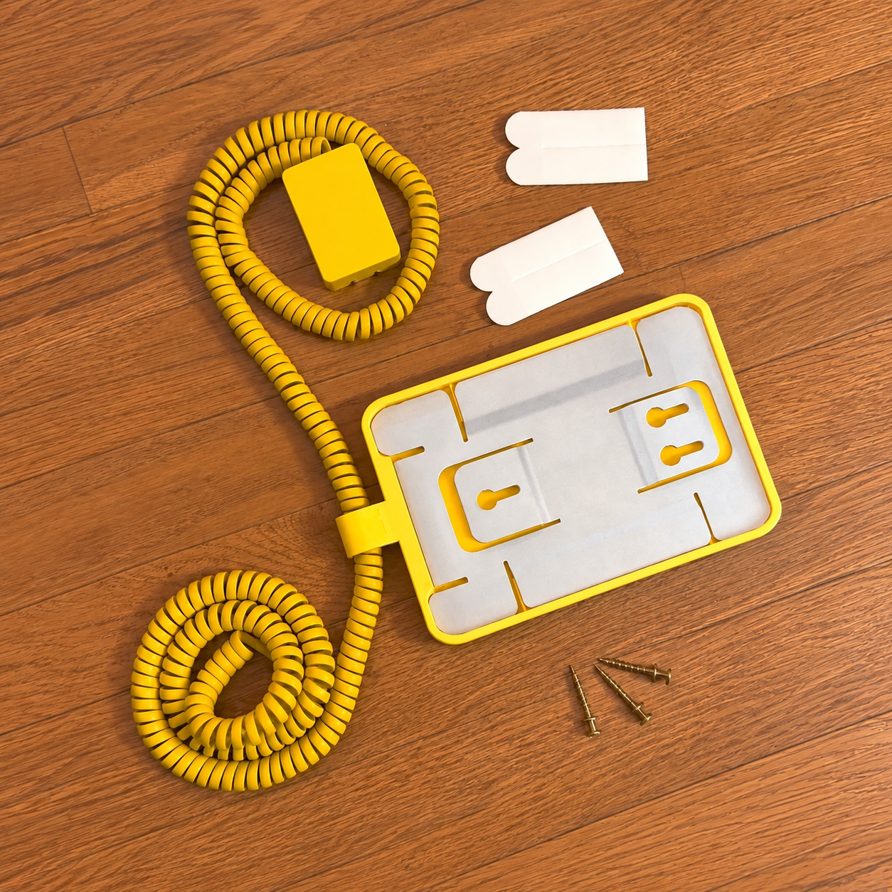 Original reverse side, coiled cable, wall plug, mounting strips and screws