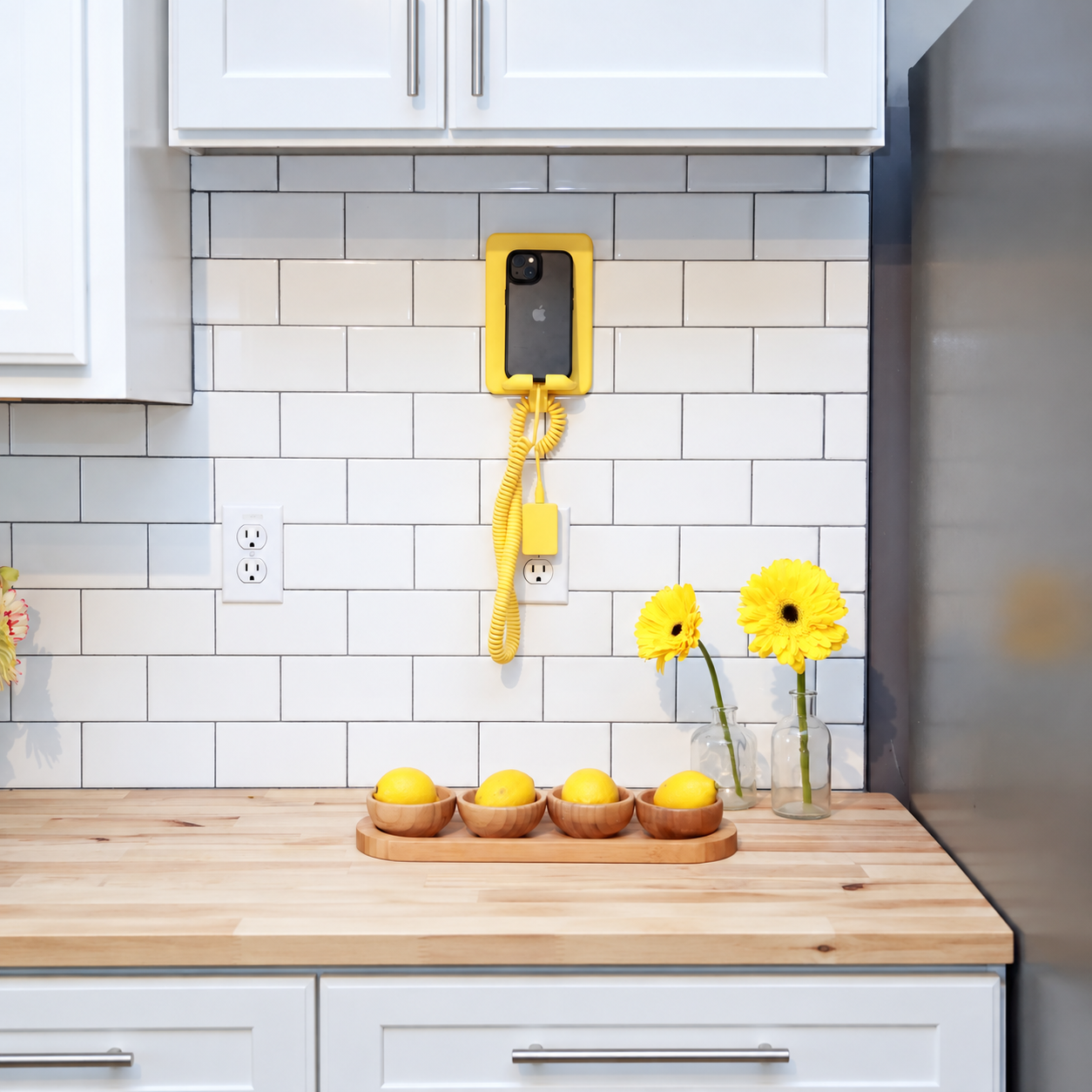 Original yellow phone dock and charger in a tiled kitchen