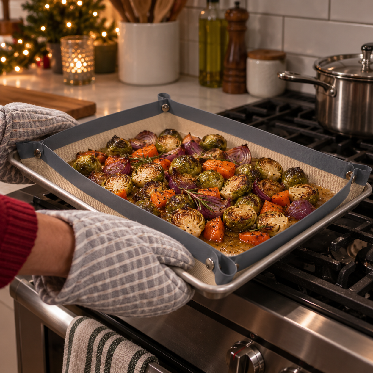 Gray snap-corner baking mat holding roasted vegetables and juices on a sheet pan