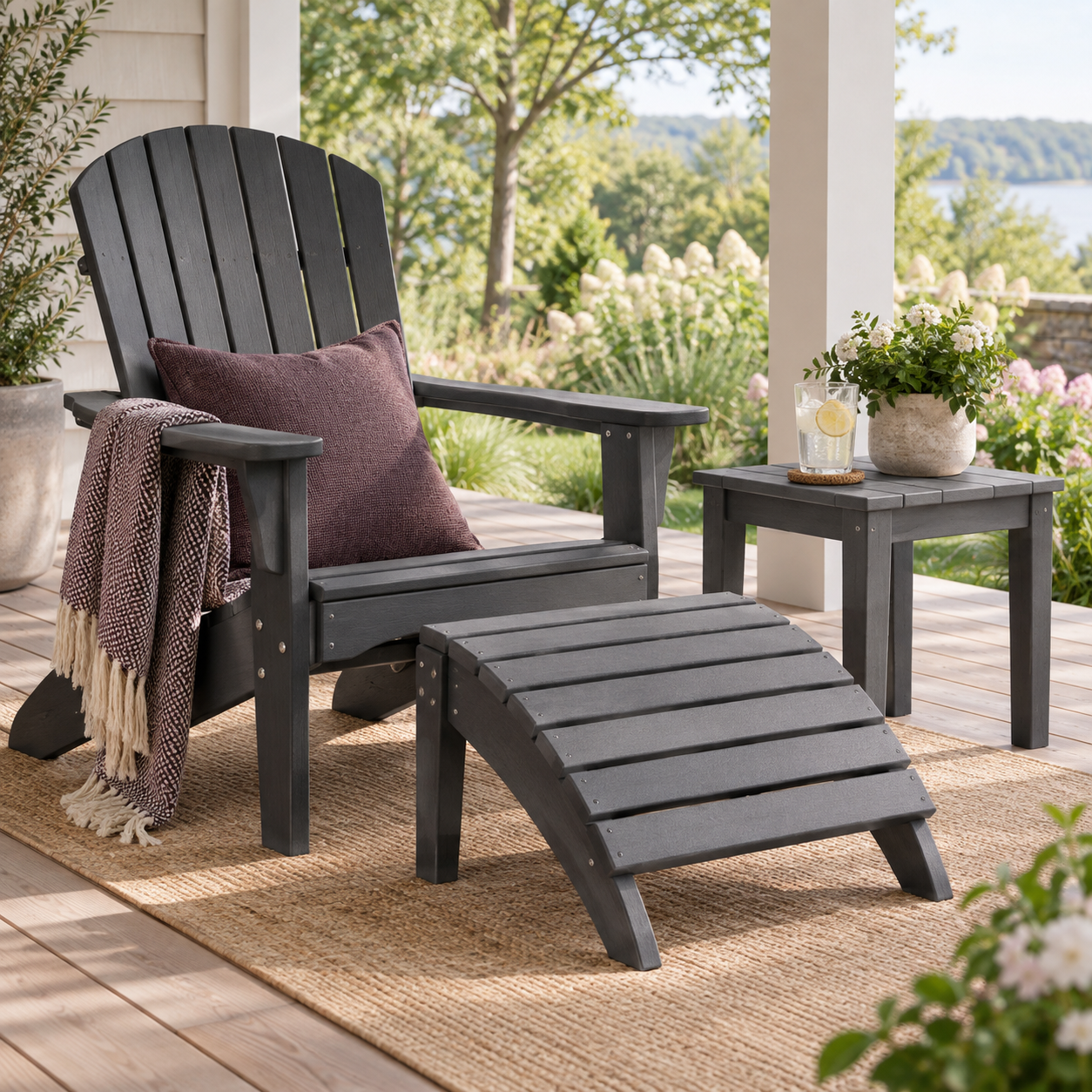 Graphite outdoor chair with matching footrest and side table on a covered porch