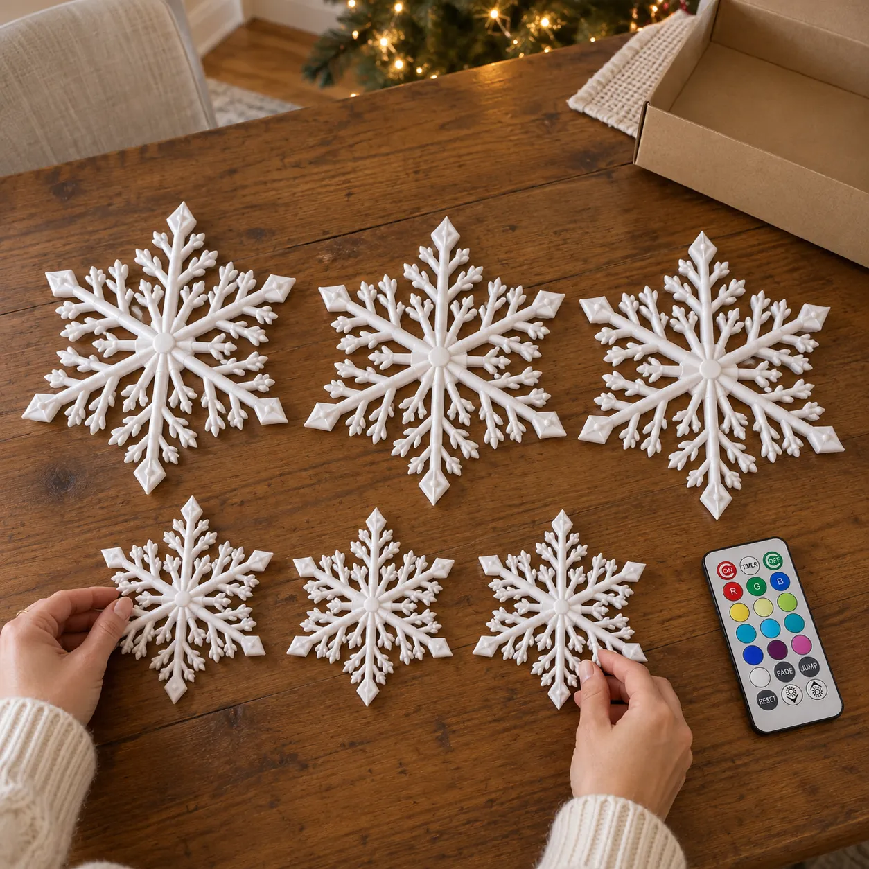 Three large and three small white snowflake lights with one remote