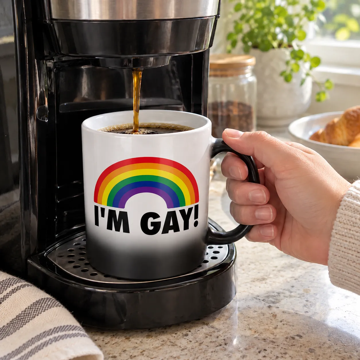 Hot coffee revealing the rainbow message on the mug beneath a home coffee maker