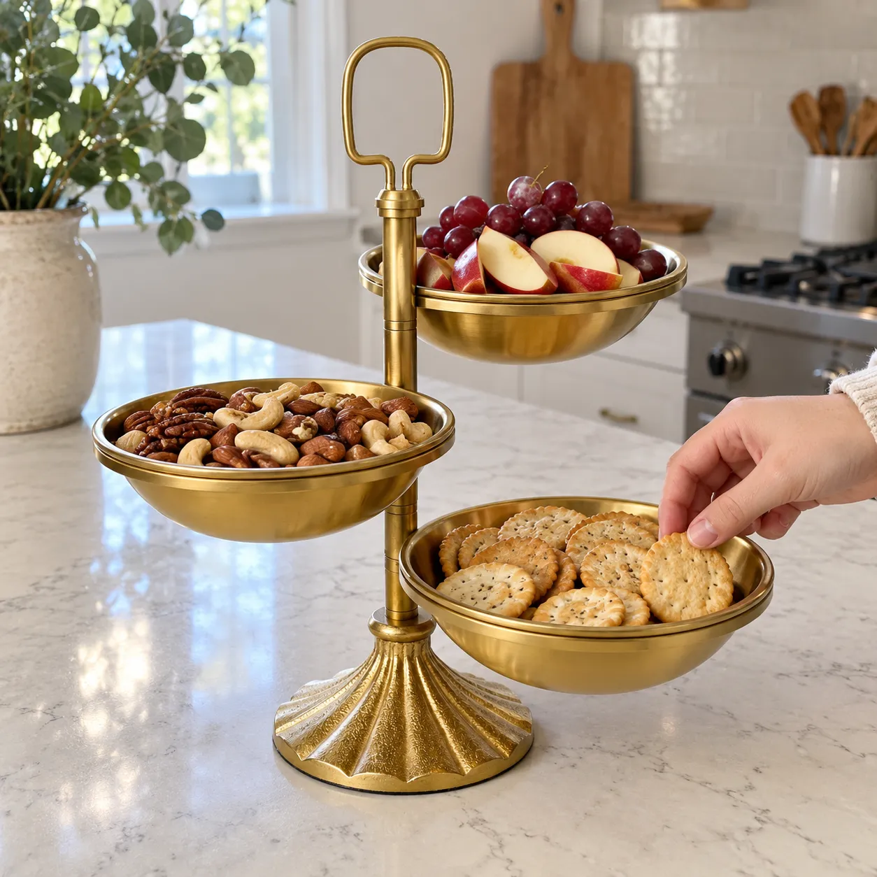Three attached bowls filled with fruit, mixed nuts, and crackers