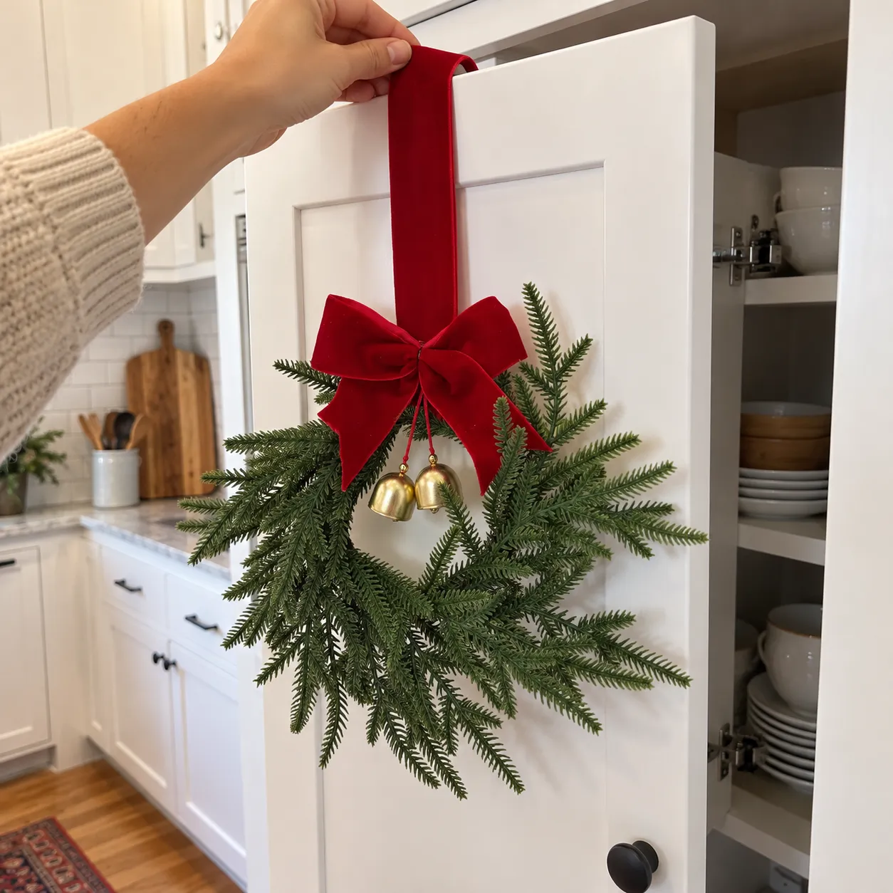 Hand placing the red ribbon over a cabinet door