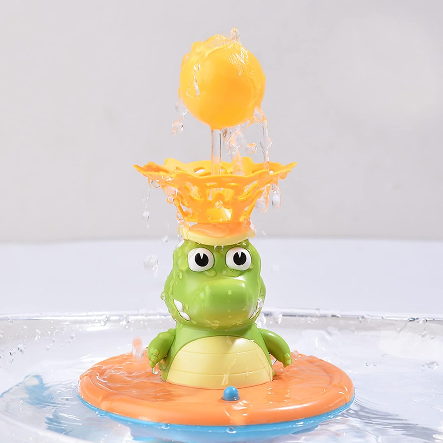 Green crocodile fountain toy with ball spray accessory