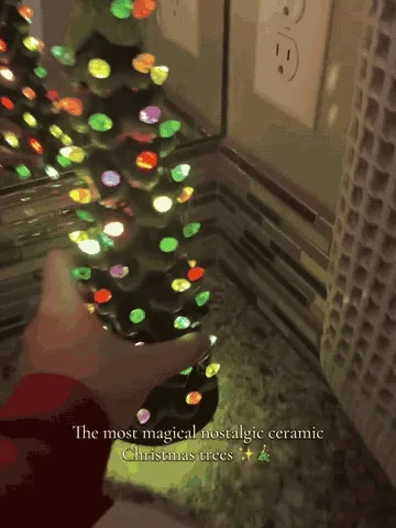 Battery-operated ceramic Christmas tree lights glowing with the underside compartment and switch shown