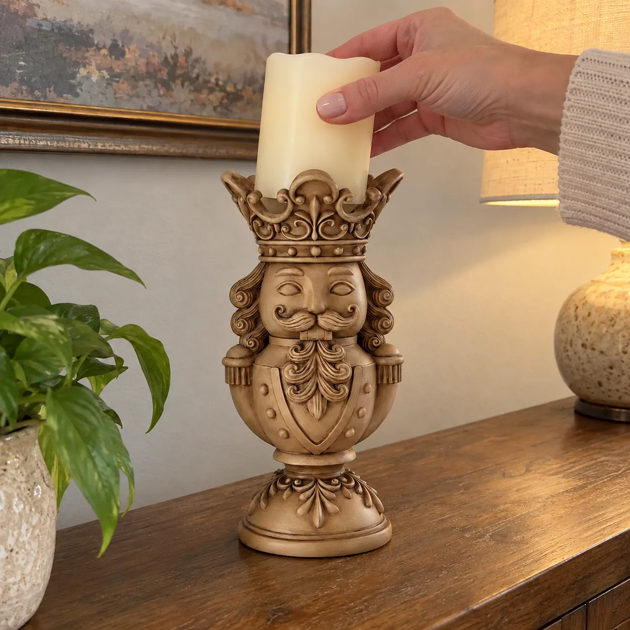 Hand placing a pillar candle securely in the nutcracker holder crown