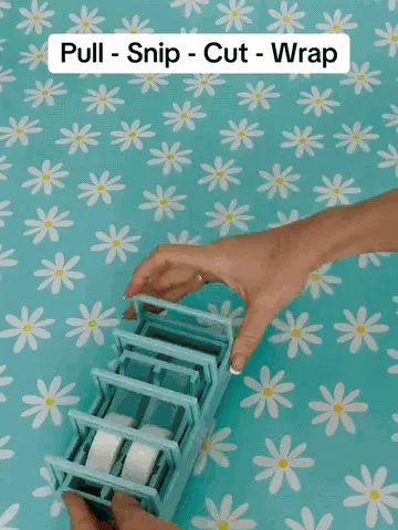 Tape prep station demonstration showing tape pulled across the guides, cut into strips, and used for wrapping