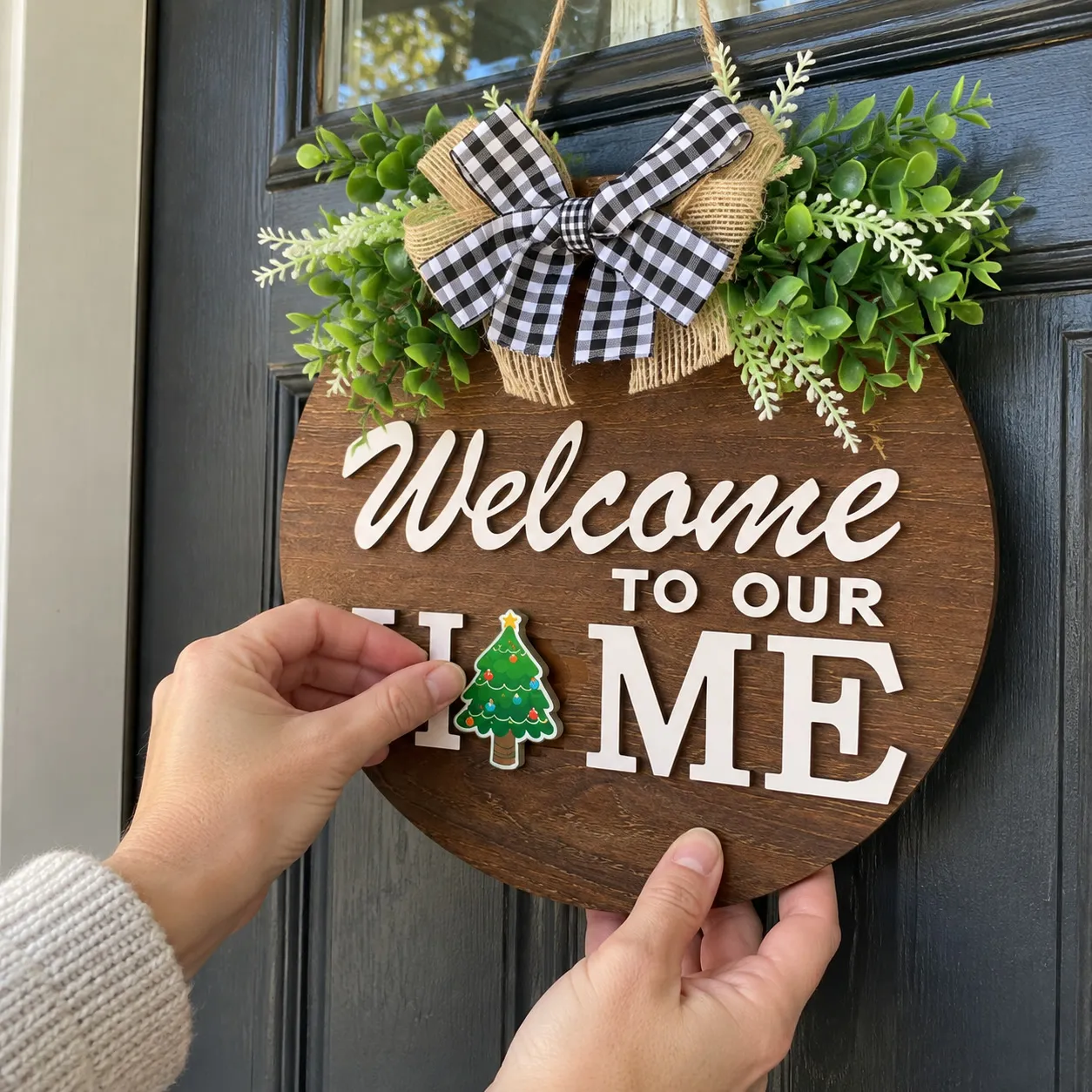 Hands changing the Christmas tree icon on the wooden welcome sign