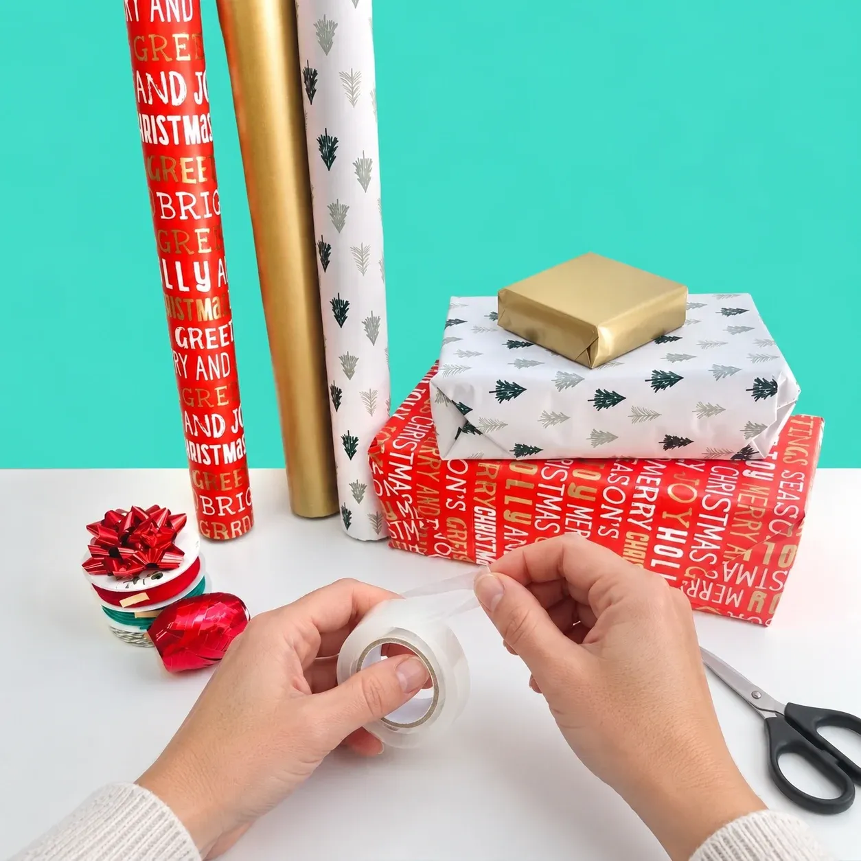 Traditional gift wrapping with a loose tape roll and scissors, without the tape prep station