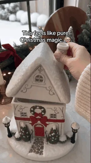 Christmas village aroma diffuser being filled with water and used