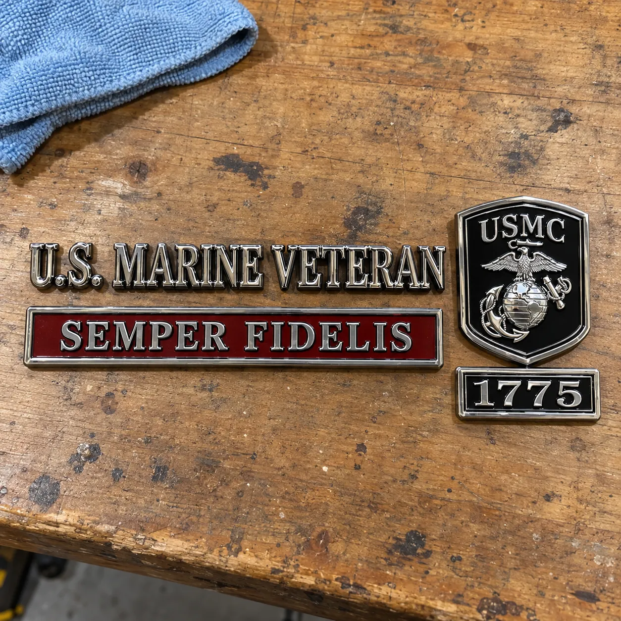 Complete Marine Corps emblem set displayed on a wooden worktable
