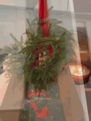 Norfolk pine bell wreath decorating cabinets and a chair