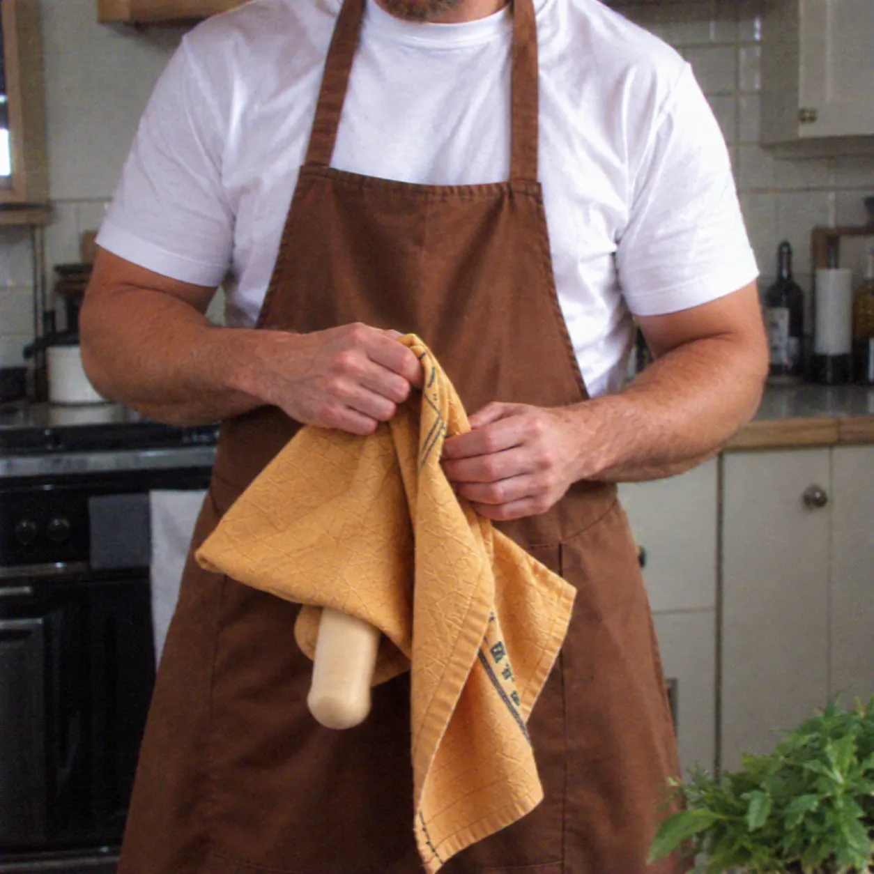 Man lifting the attached towel to reveal the concealed apron prank
