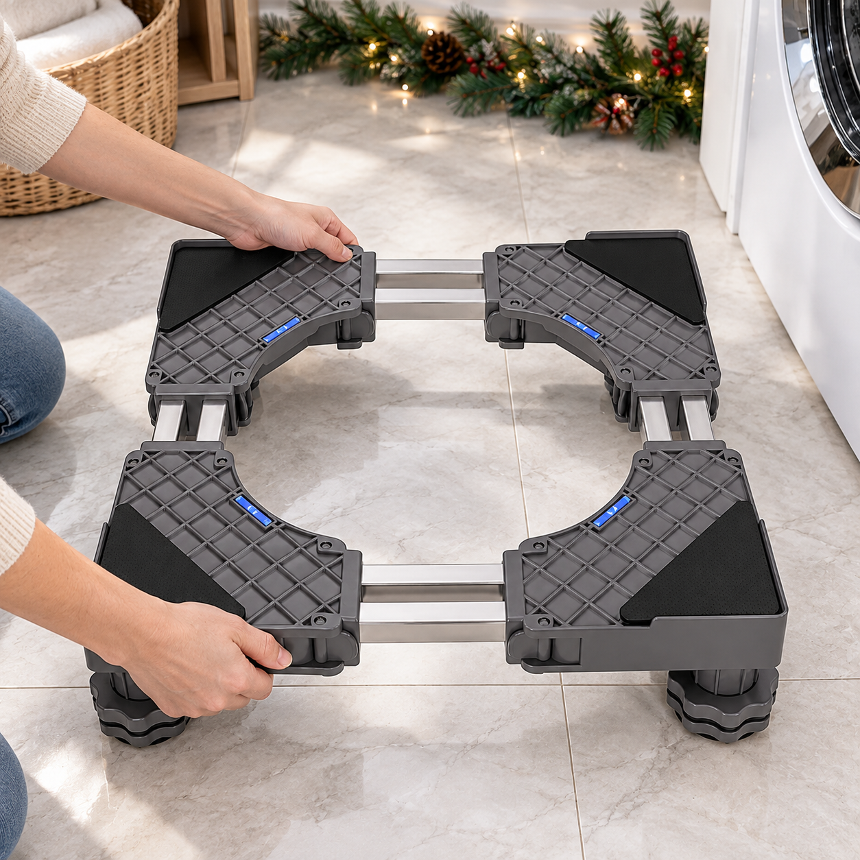 Hands adjusting the width of a four-leg appliance base