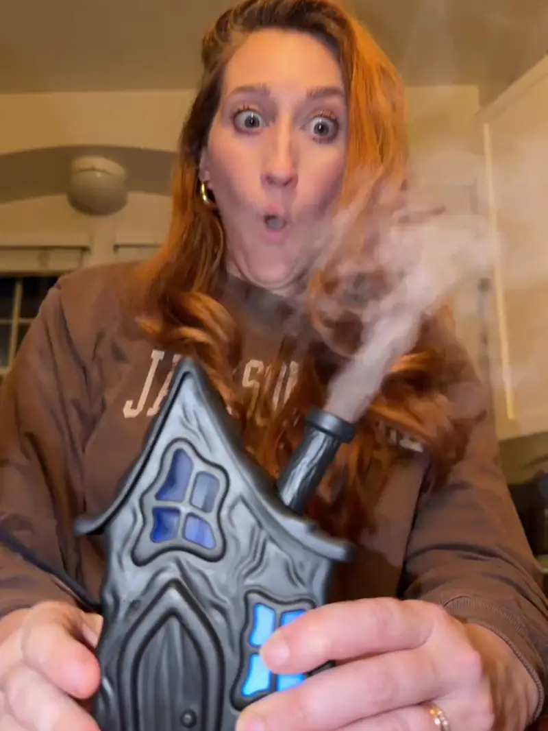 Haunted house humidifier being filled and producing mist from its chimney