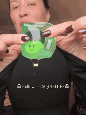 Hands squeezing and showing the Halloween character squishy cubes
