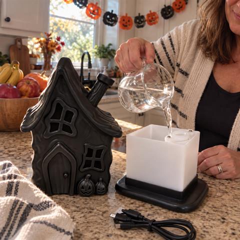 Customer refilling the removable tank of the haunted house humidifier