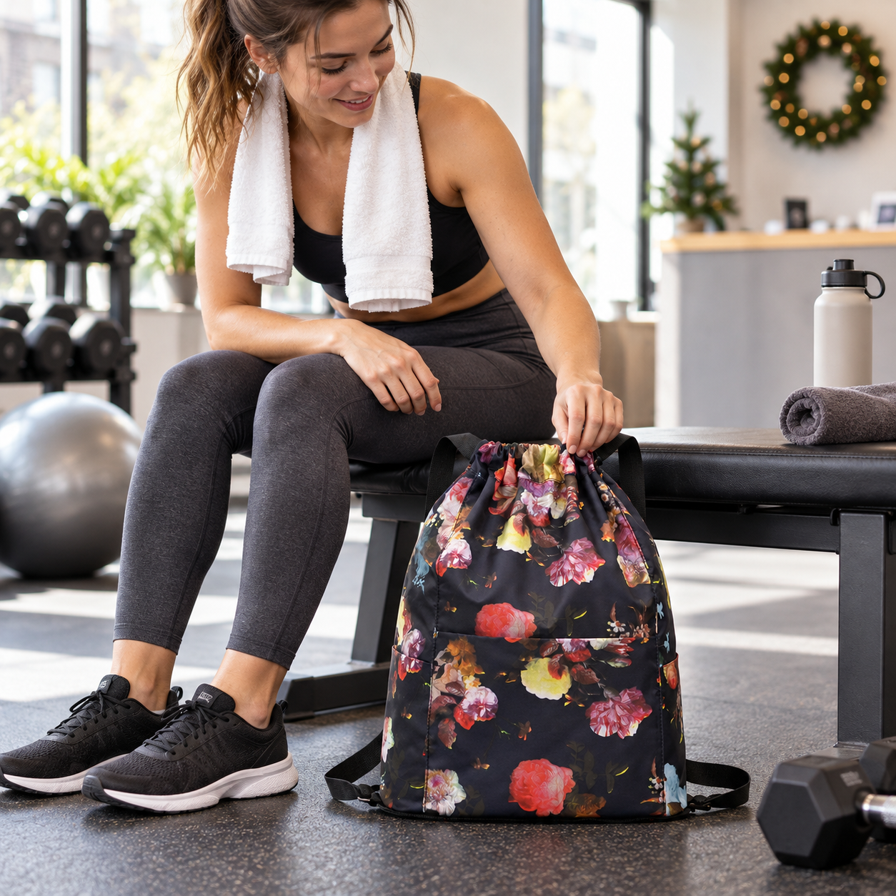 Floral drawstring backpack beside a gym bench