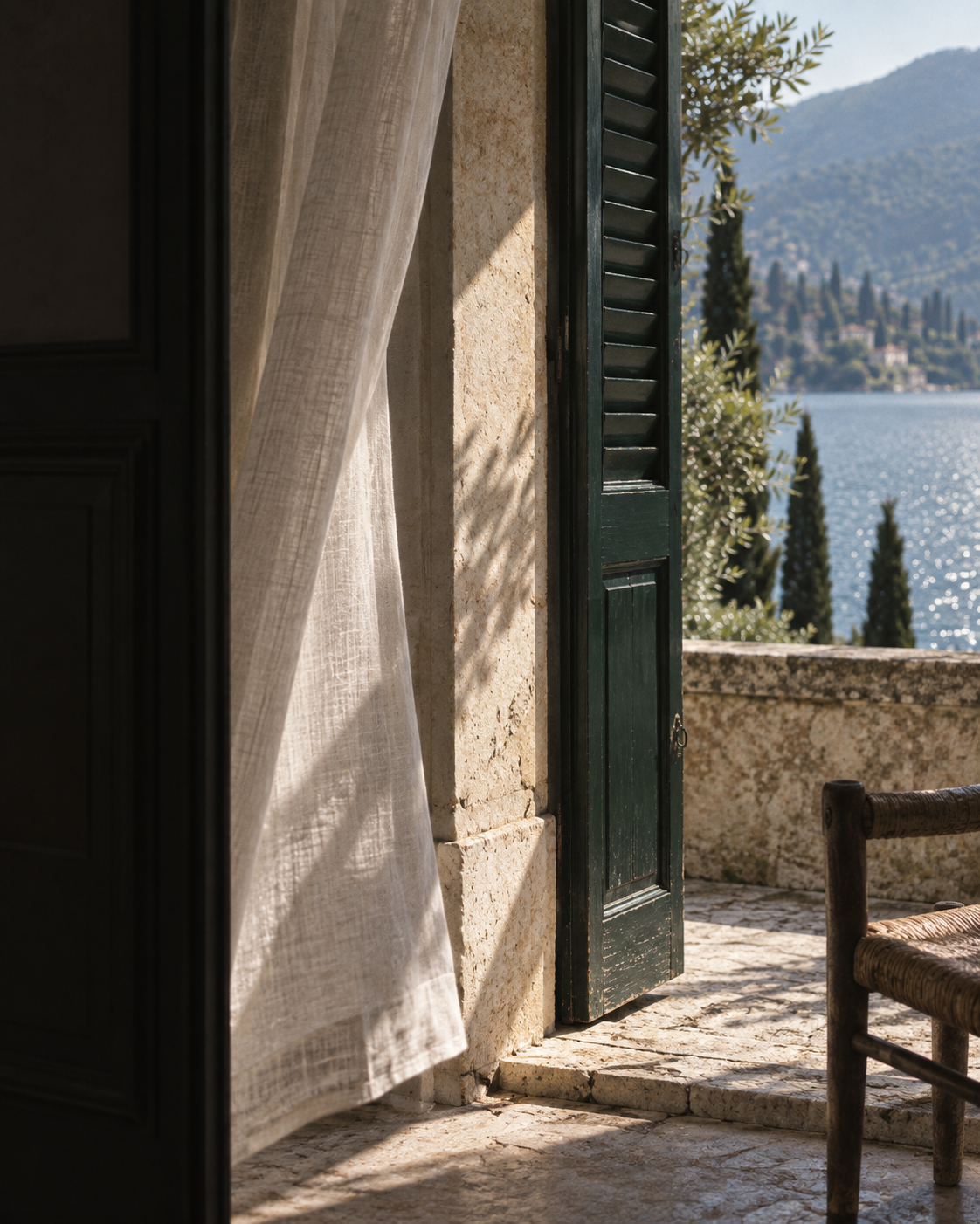 Light enters through a green shutter onto a stone terrace.