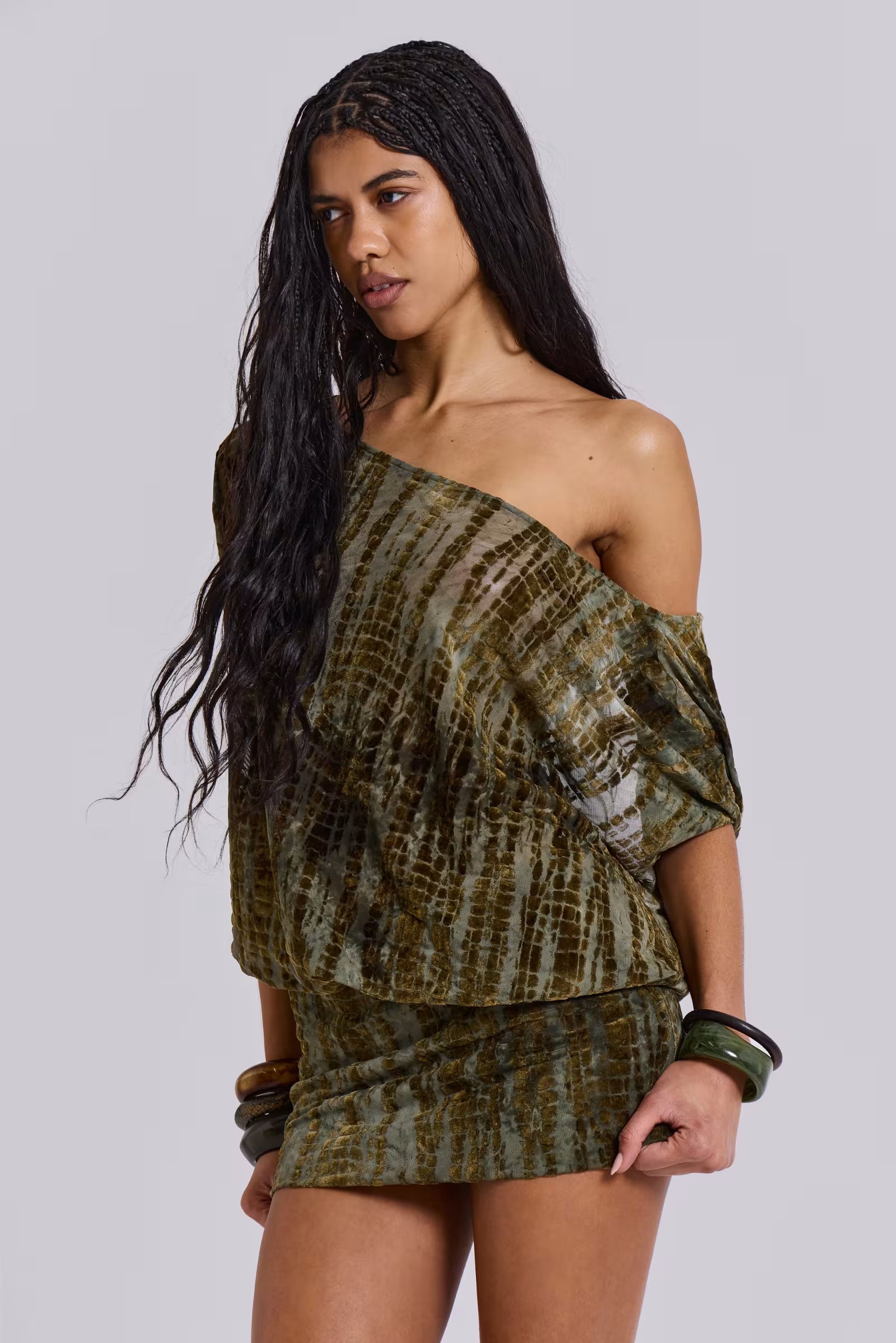 Front angle of olive devoré velvet off-shoulder mini dress with textured fabric