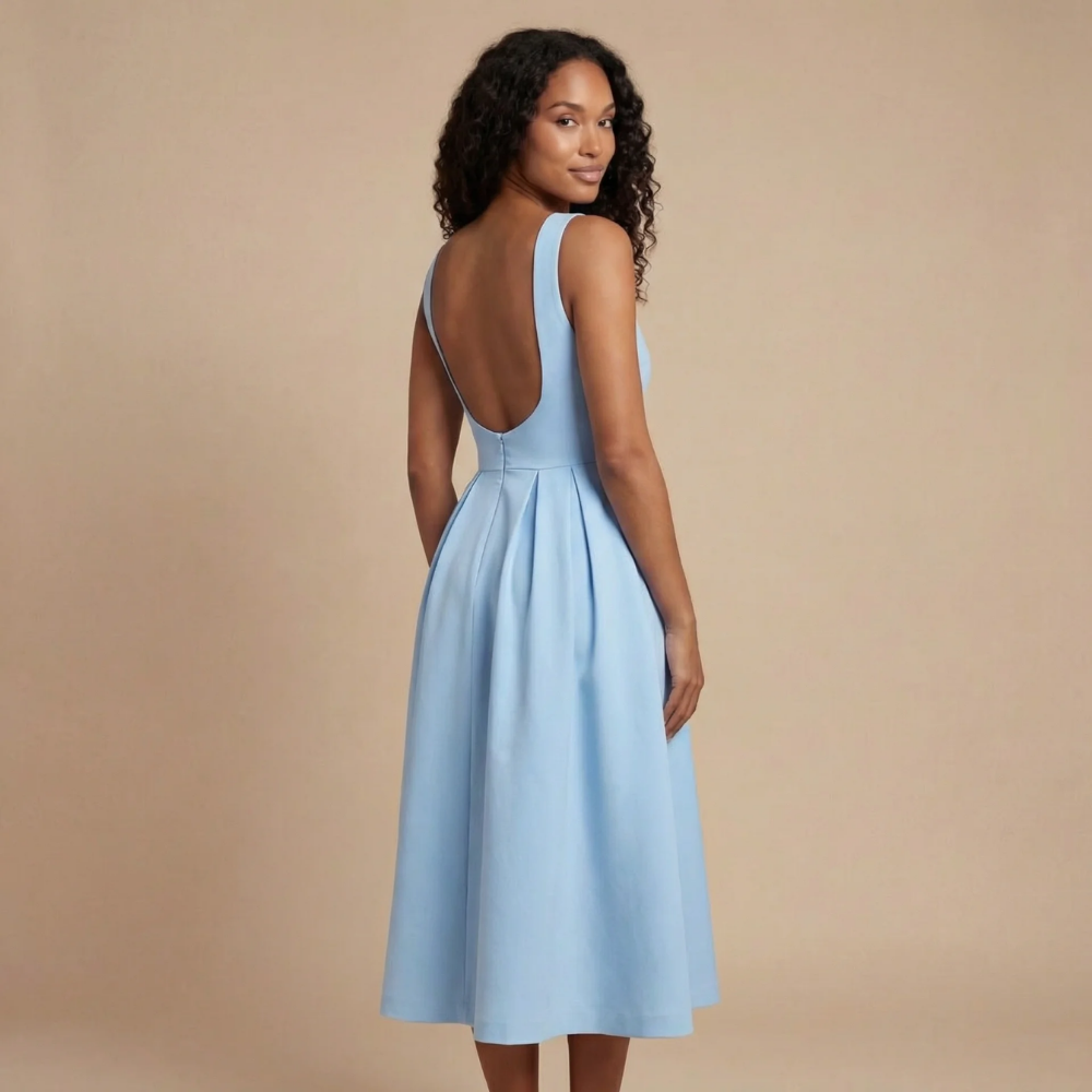Back view of light blue midi dress showing low scoop back and pleated skirt