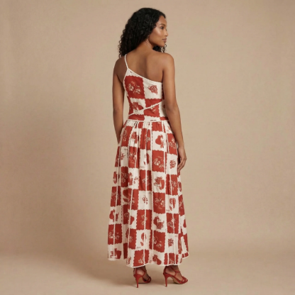 Backless view of red patchwork maxi dress showing asymmetrical strap and flowing pleated skirt for women