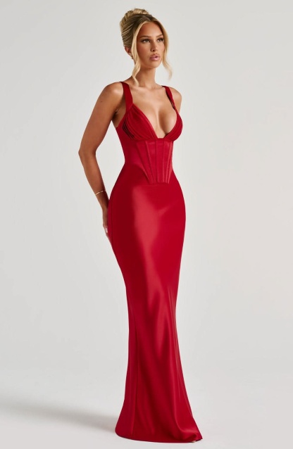 Front view of red corset maxi dress with fitted bodice and flowing skirt