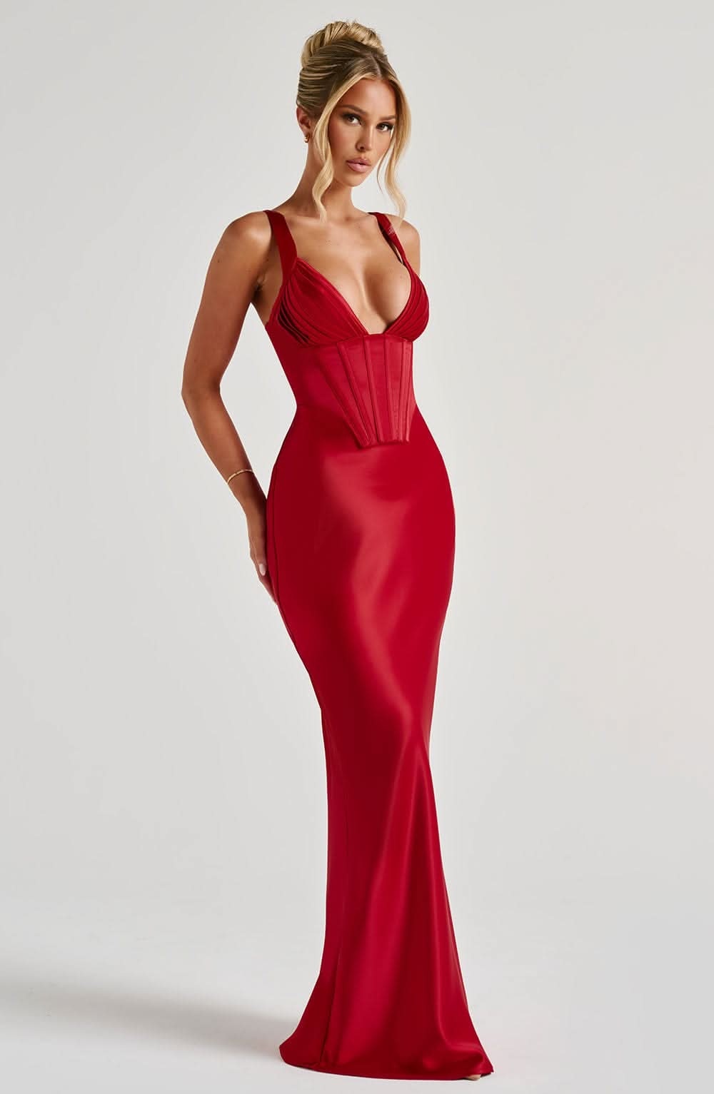 Side angle of red corset maxi dress showing corset boning and waist definition