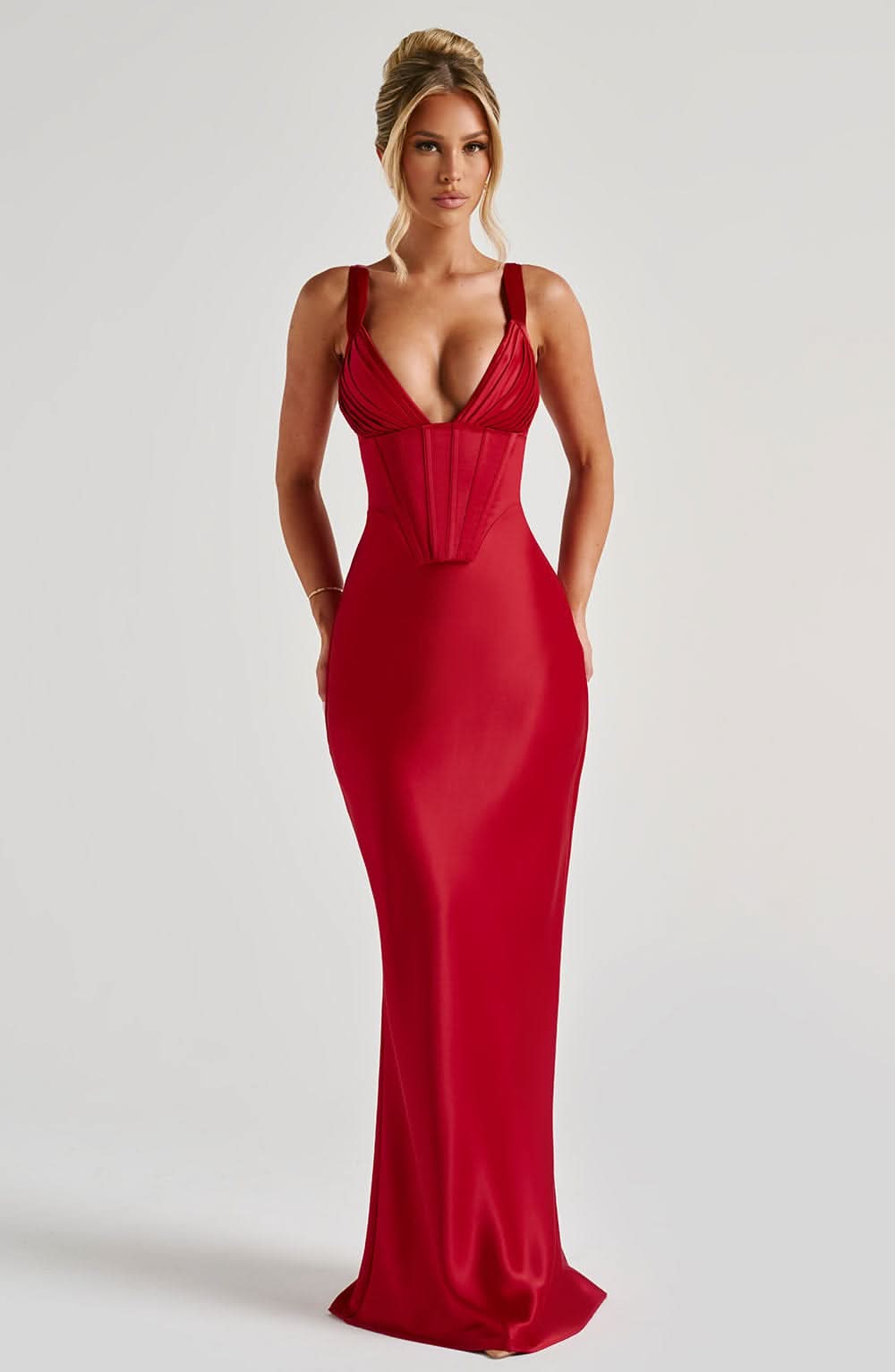 Full-length red corset maxi dress with spaghetti straps and floor-length hem