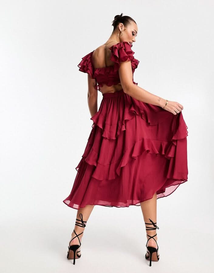 Back view of burgundy ruffle midi dress with open back and tiered ruffles