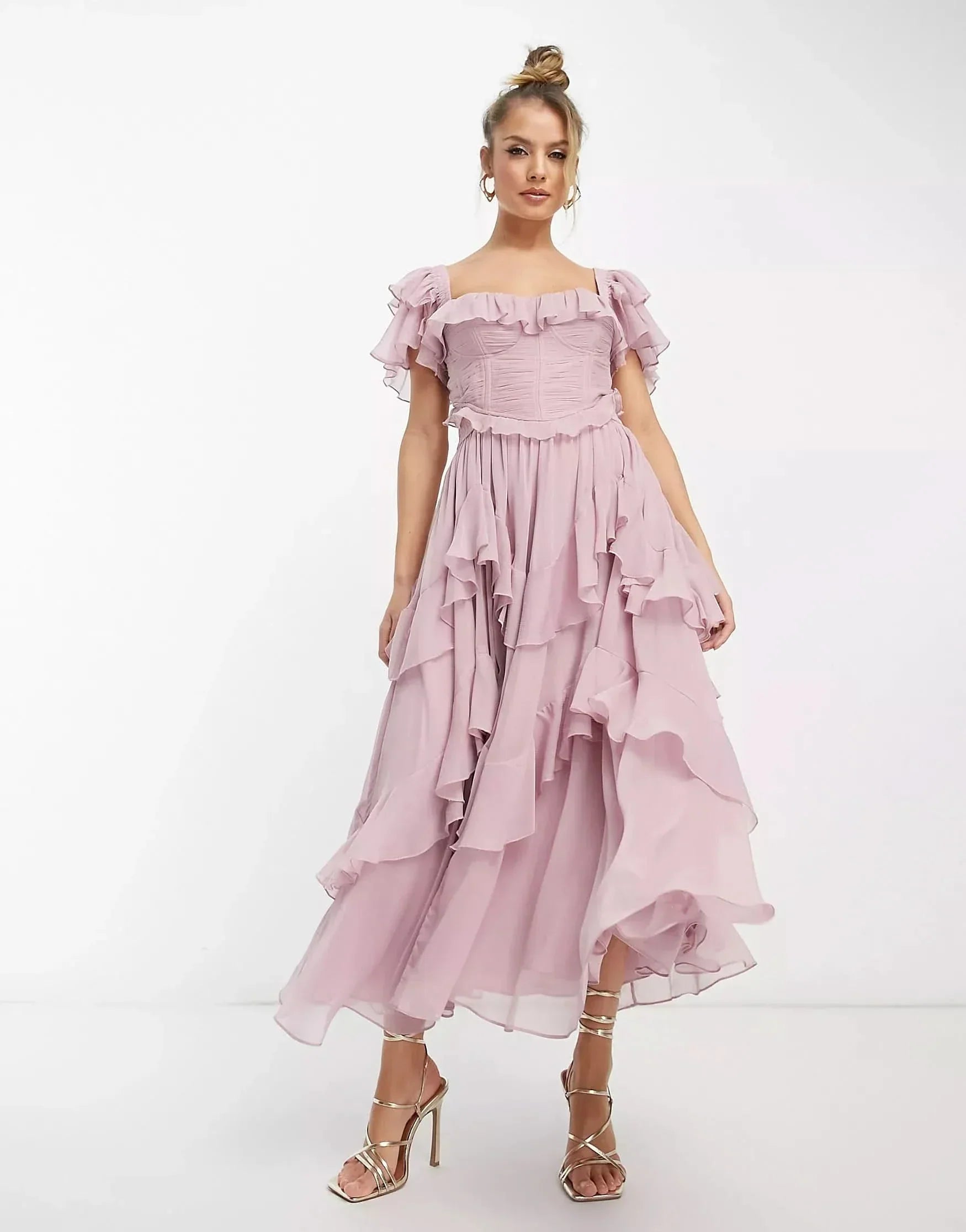 Blush pink ruffle midi dress with off-shoulder neckline and layered skirt