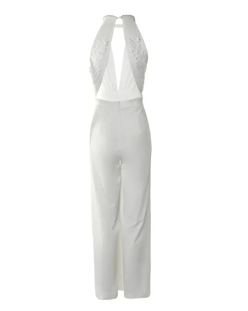 Back view flat lay of white backless jumpsuit showing lace embroidered back panel