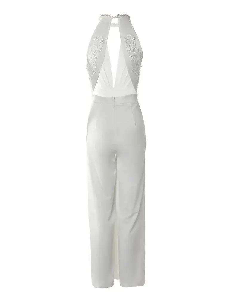 Back view flat lay of white backless jumpsuit showing lace embroidered back panel