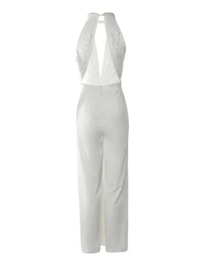 Back view flat lay of white backless jumpsuit showing lace embroidered back panel