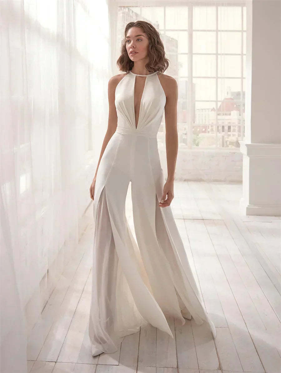 White halter backless formal jumpsuit with draped front and flowing wide legs