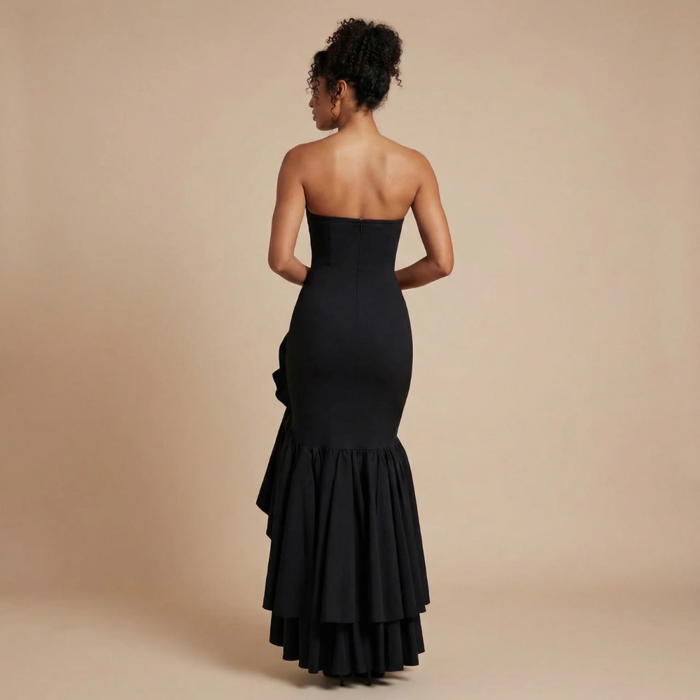 Back view of black strapless maxi dress with layered ruffle detail