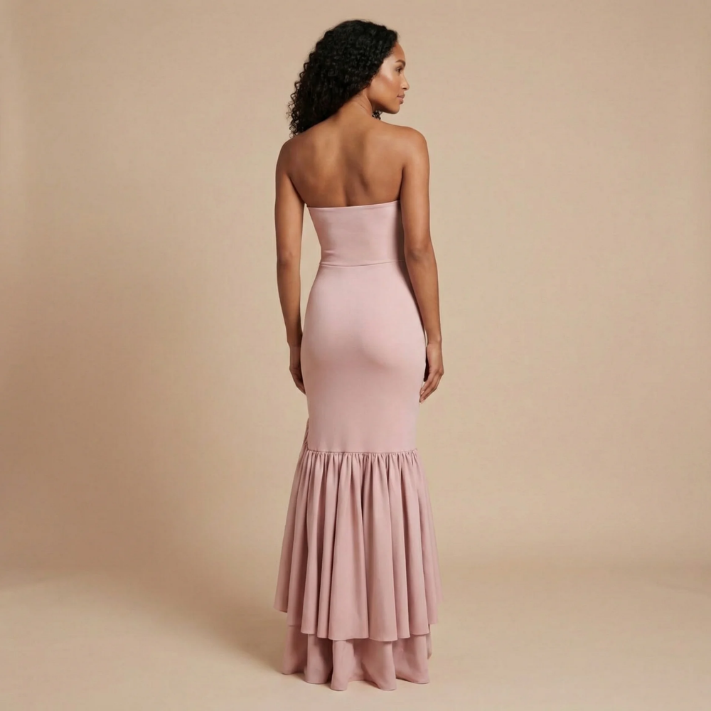 Back view of blush pink strapless maxi dress with layered ruffle hem