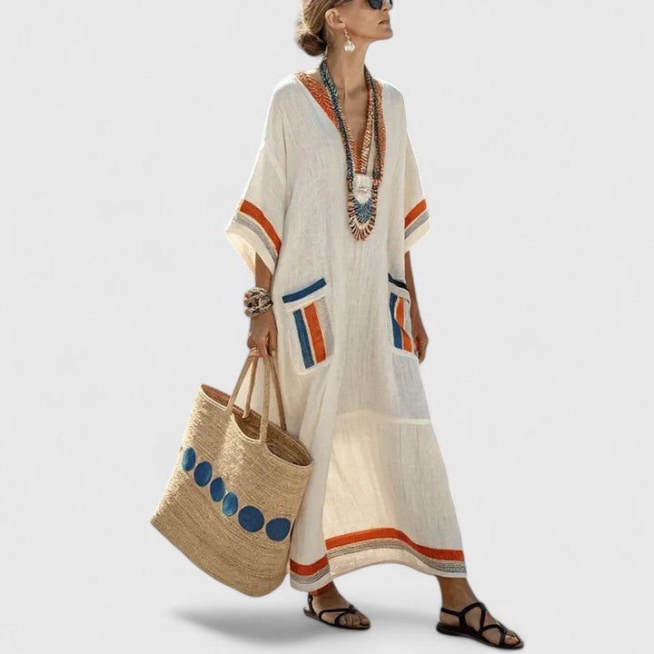 Ivory maxi dress with orange and blue striped trim and patch pockets