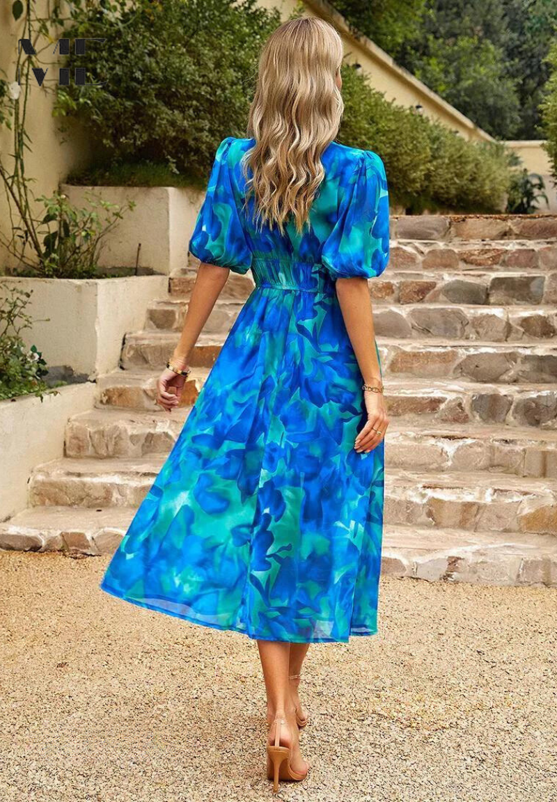 Back view of blue teal floral midi dress with puff sleeves