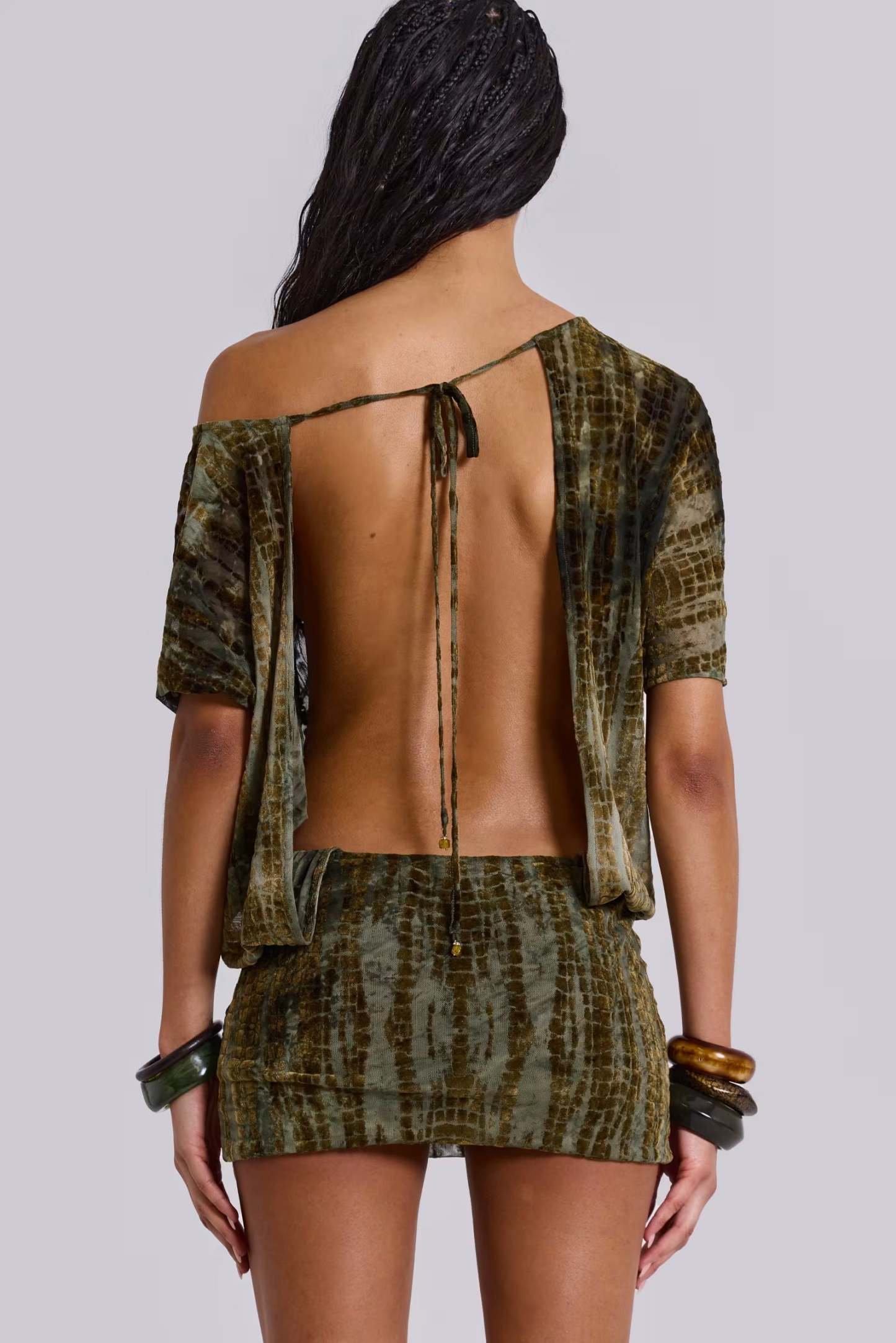 Back view of olive mini dress with open-back tie detail and bare back design