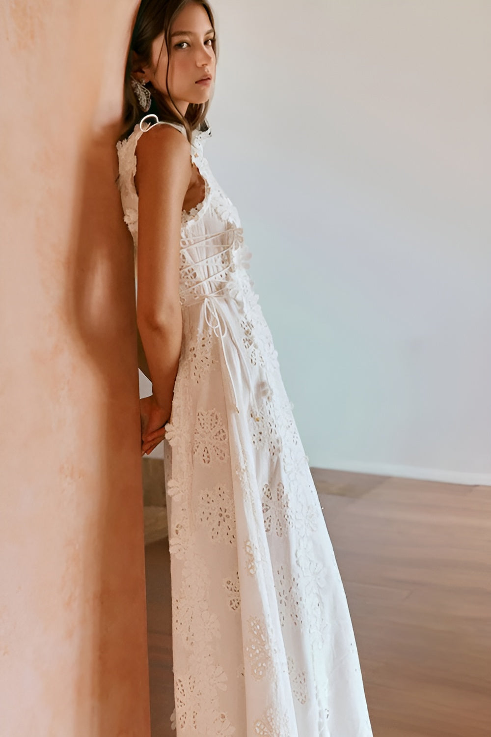 Side view showing lace-up corset back detail on white eyelet maxi dress