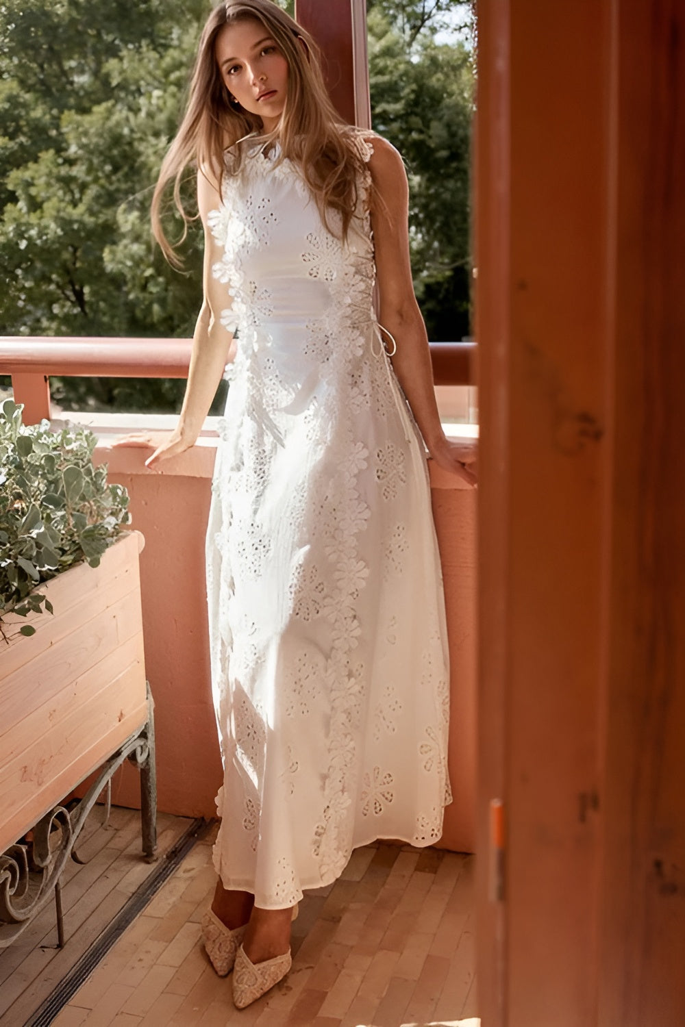 White floral eyelet maxi dress with A-line silhouette worn outdoors