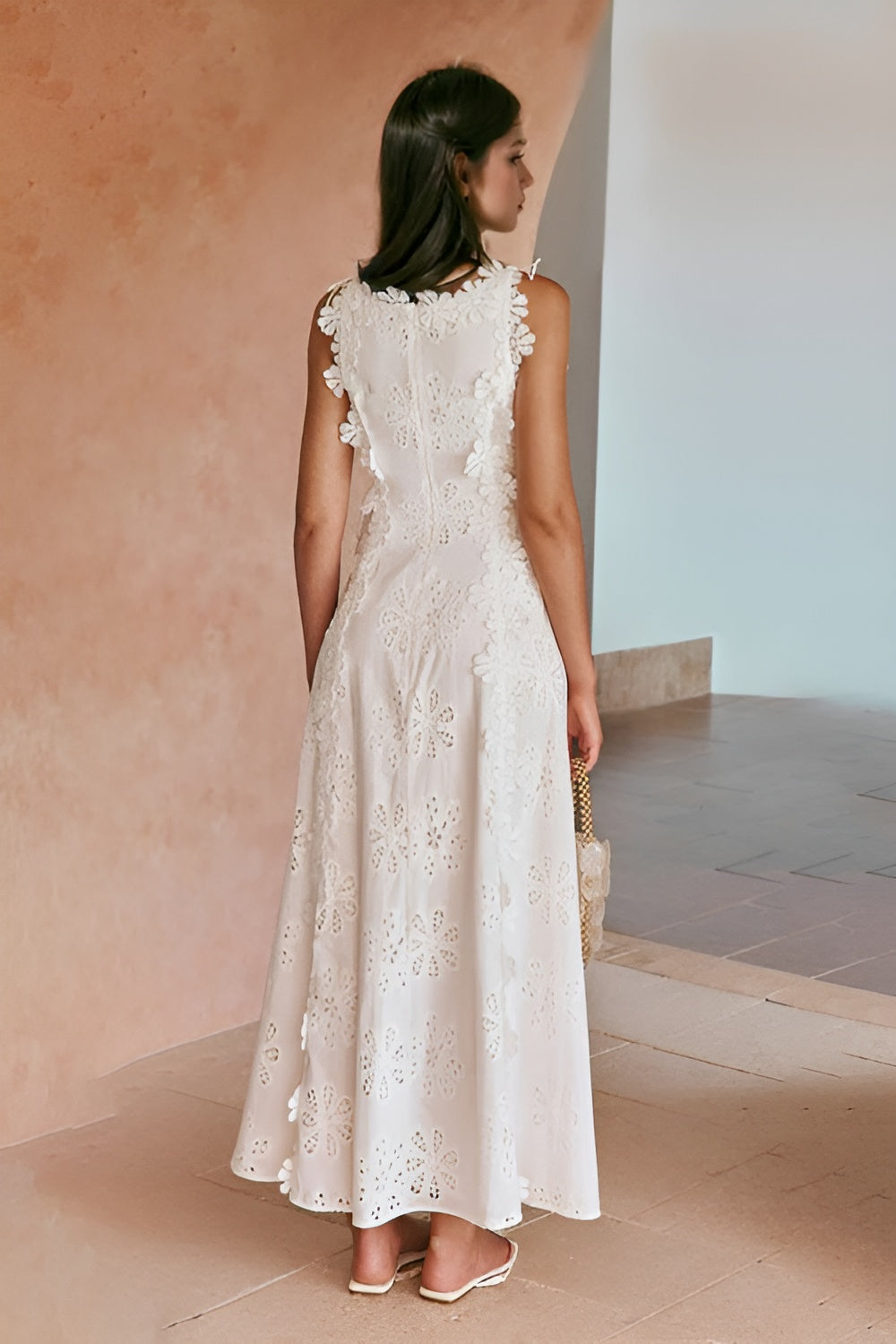 Back view of white lace maxi dress showing adjustable side lace-up ties