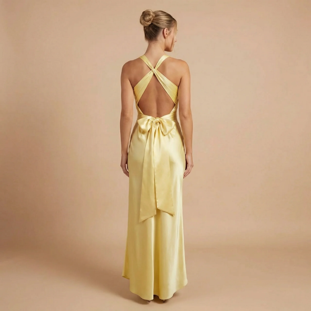 Back view of pale yellow maxi dress with crisscross straps and tied waist detail