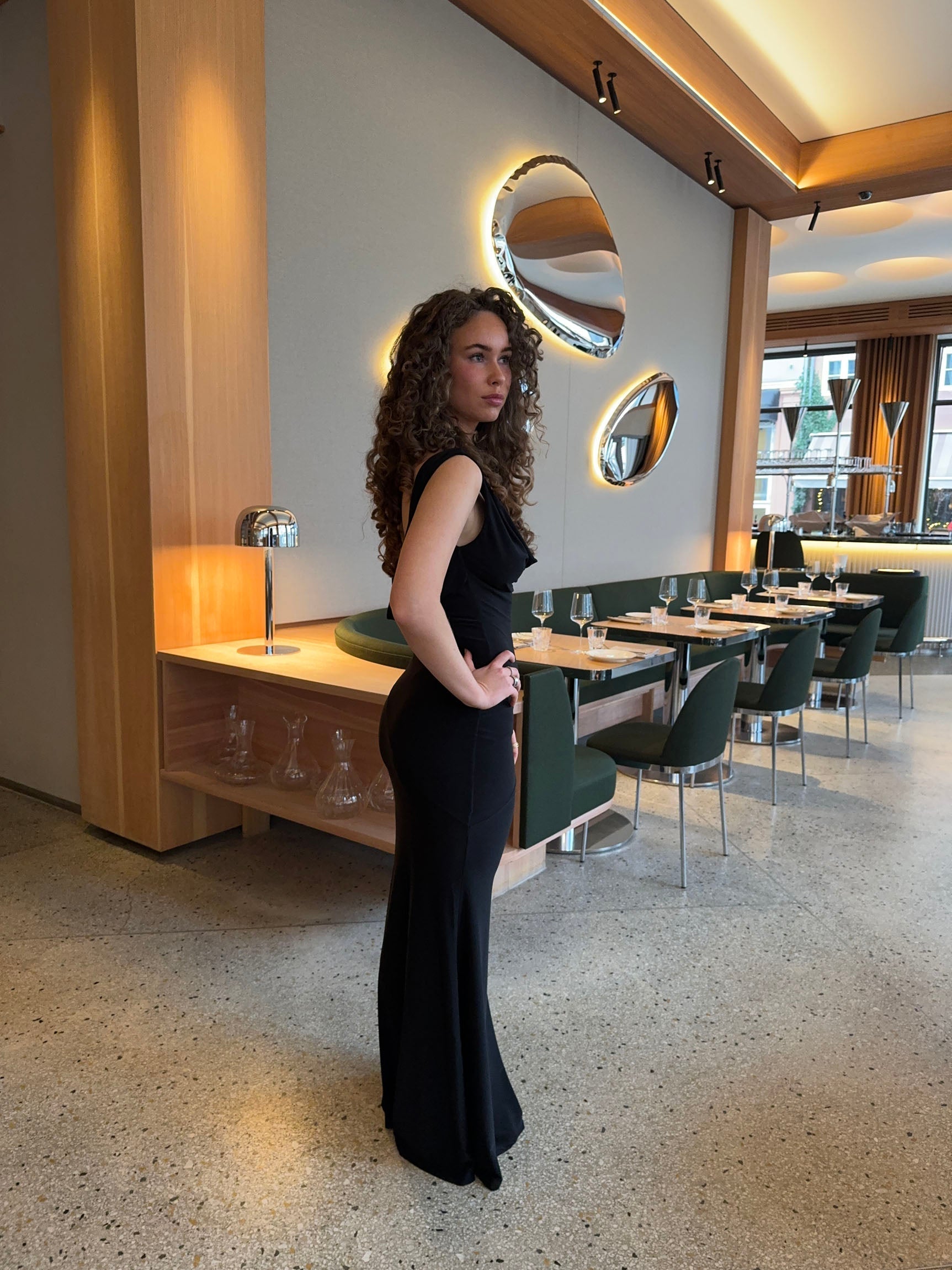 Black sleeveless maxi dress with V-neckline shown from side angle