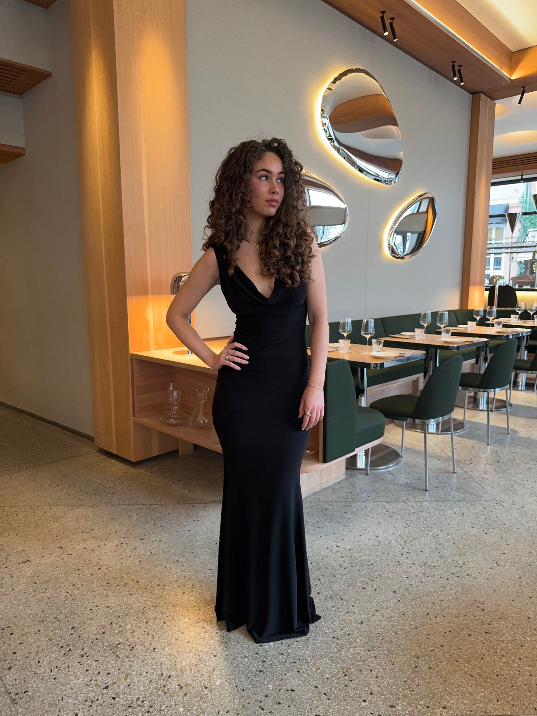 Black sleeveless maxi dress with deep V-neckline and backless design