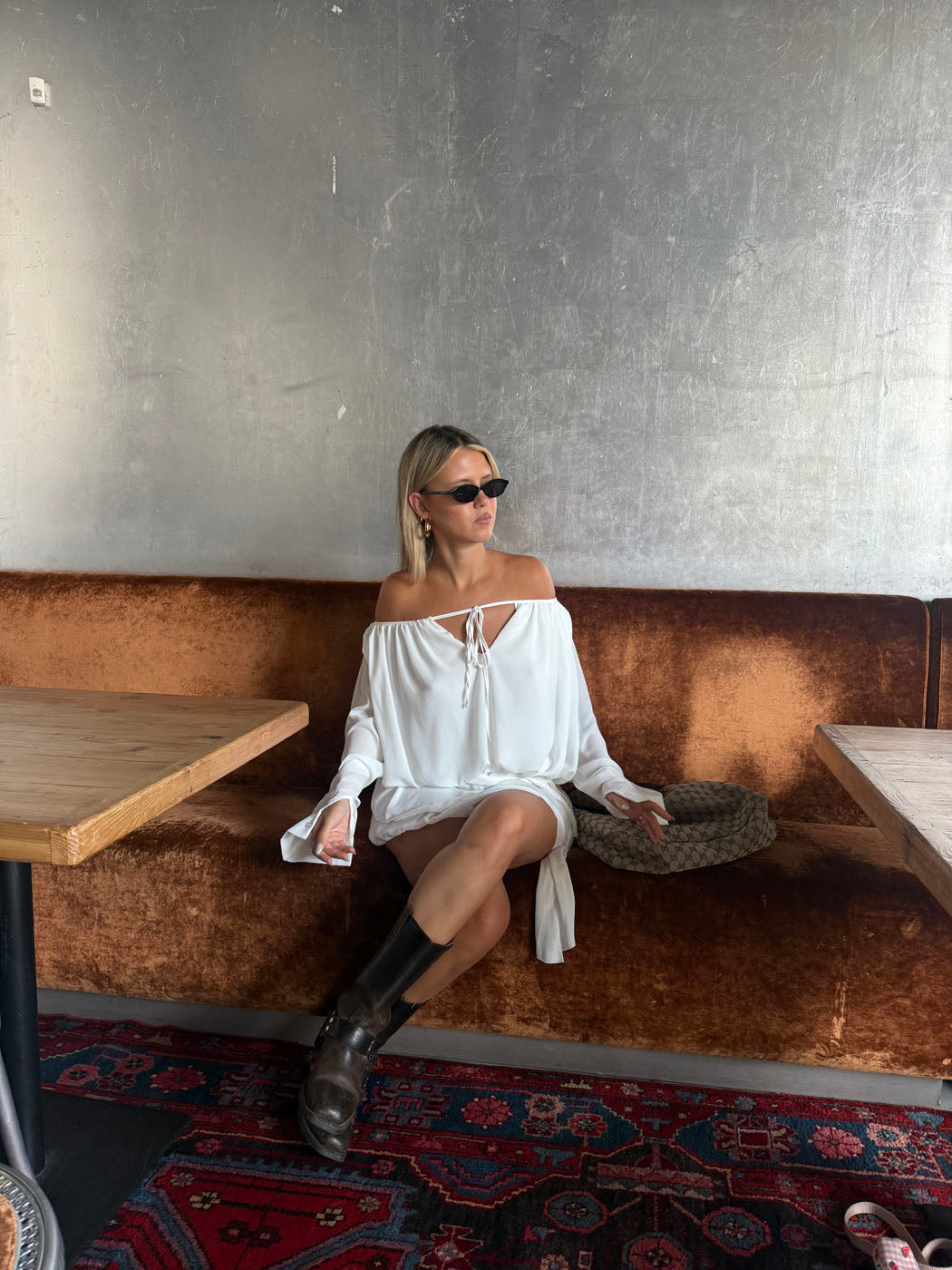 White ruffle mini dress with long sleeves, keyhole neckline, and gathered silhouette