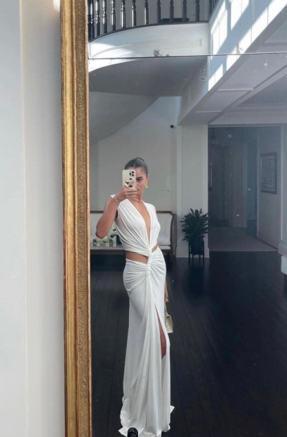 Ivory maxi dress with front cutout detail and high leg slit, mirror selfie view